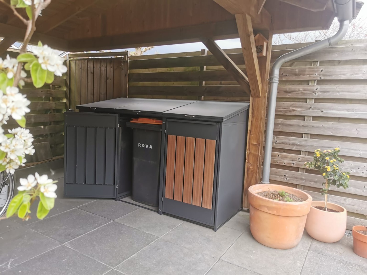 Bin store with an open door and a wheelie bin inside
